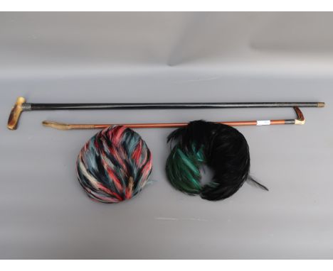 Two ladies feather hats, a horn handled walking stick and an antler handled riding crop 