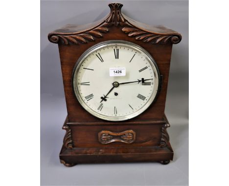 Early Victorian mahogany bracket clock, the shaped case with carved decoration, the circular painted dial with Roman numerals