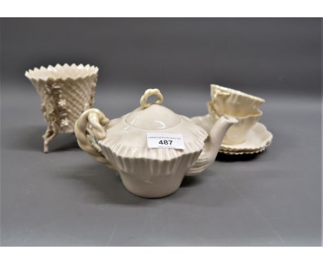 Belleek white and pale yellow teapot, floral encrusted vase and a pair of teacups and saucersCup, saucers and teapot - All in