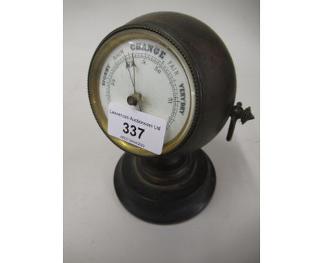 Late 19th / early 20th Century brass cased ball form desk barometer with enamel dial, ring side handles and ebonised circular