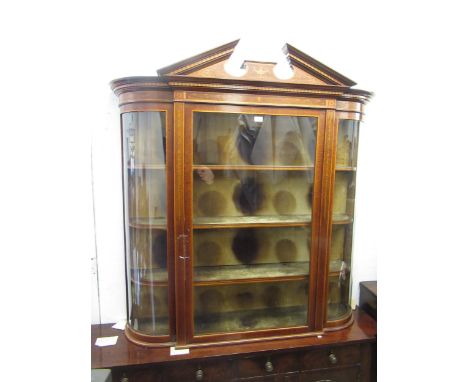 Edwardian mahogany and marquetry inlaid wall cabinet, the broken arch pediment above a glazed door enclosing velvet lined she