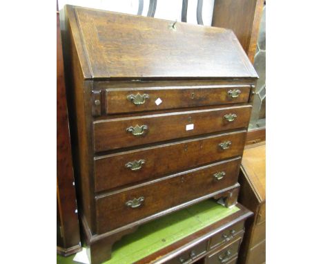 Small George III oak bureau, the fall front enclosing a fitted interior above four graduated drawers with brass handles and b
