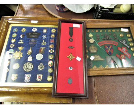 Collection of various military badges, button, enamel badges, medallions etc., housed in three frames 