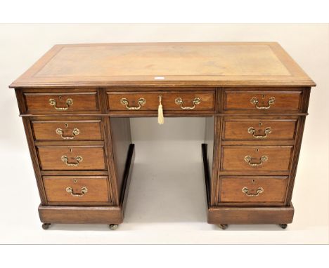 19th Century mahogany twin pedestal desk, having tan leather inset top above an arrangement of nine draws with brass swan nec