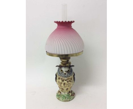 Early 20th century Continental novelty oil lamp, with pink opaline glass shade, the base in the form of an owl, total height 