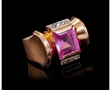 Art Deco 1940s diamond and pink stone dress ring of 'Odeonesque' design, the rectangular step cut pink stone flanked by rose 