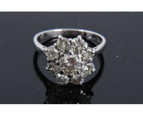 Diamond cluster ring with a flower head cluster of nine brilliant cut diamonds in claw setting on 18ct white gold shank, esti