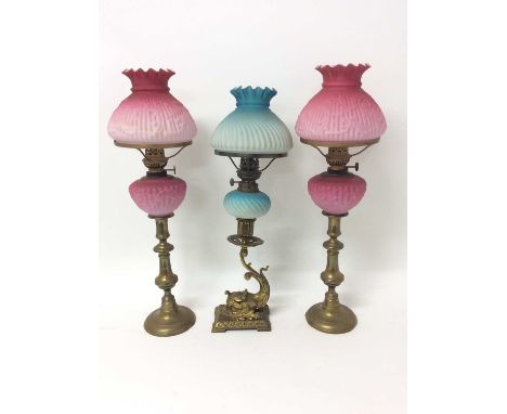 Pair of Edwardian peg lamps, with pink opaline glass shade and reservoir and brass candlestick base, 51cm high together with 