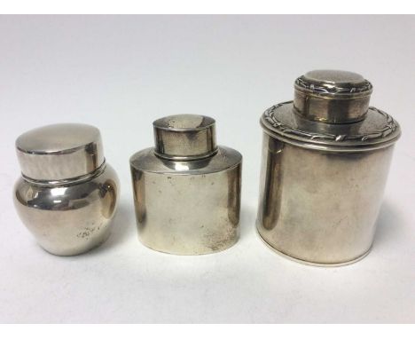 George V silver tea caddy of cylinderical form with push fit cover, together with two other silver tea caddies (various dates