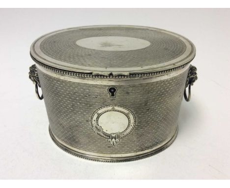 Victorian silver plated teacaddy of oval form with engine turned decoration, twin lion mask handles, beaded foot and top rims