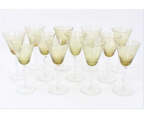 Set of twelve Venetian wine glasses, the yellow bowls engraved with figural scenes, over rope twist stems and conical feet, 1