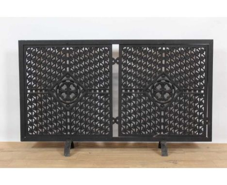 Unusual metal fire screen, utilising man hole covers, 103cm wideProvenance: Property of a Lady, removed from a Hertfordshire 