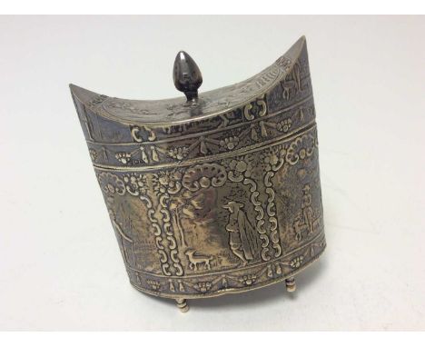 Dutch silver tea caddy of navette form with embossed figural decoration and hinged cover, raised on four feet (one detached b