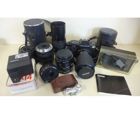 A Pentax P30 camera with an assortment of lenses, flash and other accessories 
