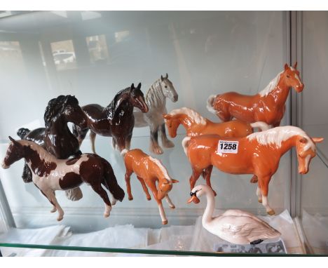 Eight Beswick figurines of seven horses, including four Palomino horses and a swan together with a Melba ware horse figurine,