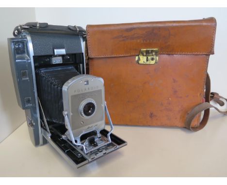 A Polaroid model 150 land camera with fitted leather case, lens appears to be in good condition, but with some wear to casing