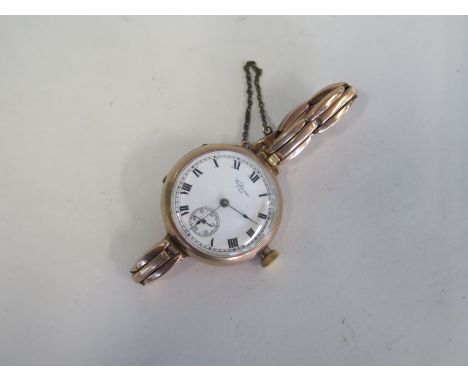 A 9ct gold Waltham wristwatch with 9ct sprung strap, manual wind running order total weight approx 35 grams 