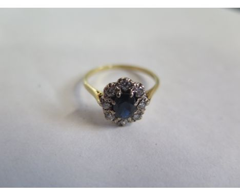 An 18ct gold sapphire and diamond ring, sapphire approx 7mm oval, ring size R, approx 3.1 grams, diamonds bright but some sur