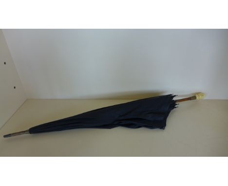 A vintage Kendall umbrella with an ivorine resin handle, damage to nose of handle otherwise reasonably good - 90cm long 