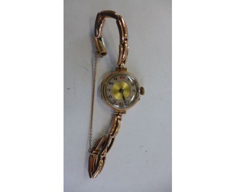 A 9ct yellow gold ladies manual wind wristwatch on a 9ct spring strap - running total weight approx 23 grams 