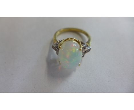 An 18ct opal and diamond ring, size O, approx 5.6 grams, in good condition 