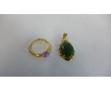 An 18ct gold ring, size K, approx 3.9 grams, and an 18ct jade pendant, approx 2.2 grams 
