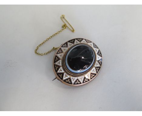 A Victorian mourning brooch with enamel decoration - 4cm x 3.5cm - generally good 