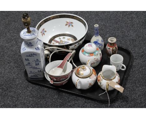 A tray containing Oriental wares including blue and white glazed table lamp, fruit bowl depicting geishas, ginger jar with ch