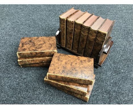 An oak Art Deco book trough together with twelve volumes of British Encyclopaedia 