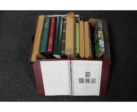 A box of a quantity of stamp albums containing a large collection of assorted stamps, first day covers 