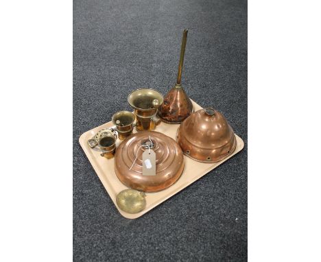 A tray containing antique brass and copper wares including a copper bed warmer, copper funnel and pos stick base, brass pestl