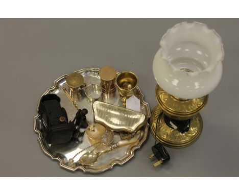 A silver plated tray with brass lamp and glass shade, silver plated purse, old brass pestle, lamp, mother of pearl spoon etc.