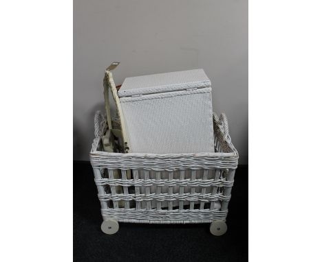 A wicker hamper on wheels together with a cream and gilt dressing table, frameless bevelled edge mirror, painted loom linen b