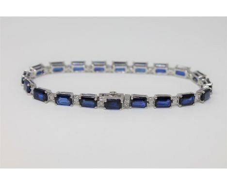 A 14ct white gold sapphire and diamond tennis bracelet, featuring 20 sapphires 12.72ct and 21 brilliant cut diamonds 0.05ct. 