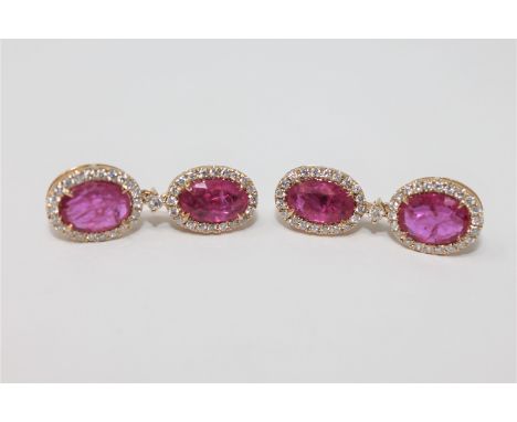 A pair of 14ct yellow gold ruby and diamond drop earrings featuring 4 rubies 4.43ct and 86 diamonds 1.27ct. With certificatio