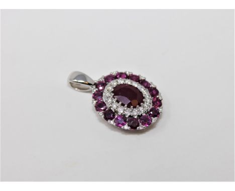A 14ct white gold ruby and diamond pendant, featuring centre ruby 1ct with 30 round brilliant cut diamonds 0.19ct and 14 natu