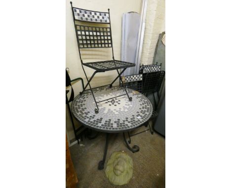A circular tile topped metal garden table with a set of four matching folding chairs, together with a concrete lionshead plaq