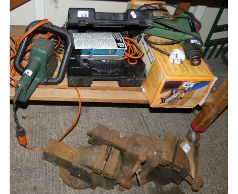 Two bench vices, electric hedge trimmers, warm air gun, mitre saw and a Black and Decker jigsaw (please note the chainsaw has