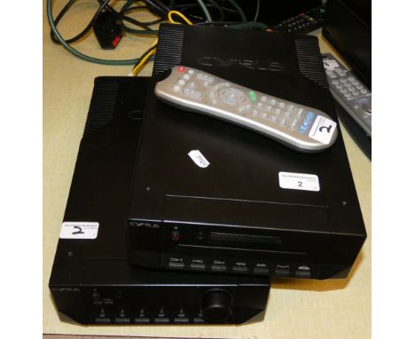 A Cyrus amplifier together with a Cyrus CD player and remote control unit