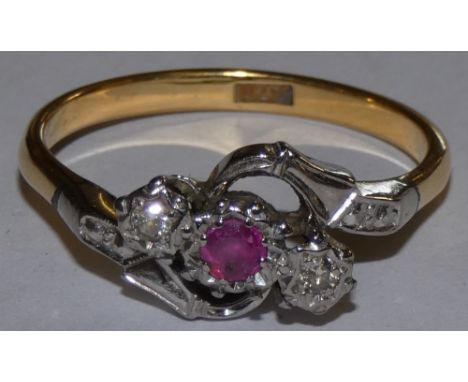 An 18ct gold ruby and diamond three stone ring of twist design