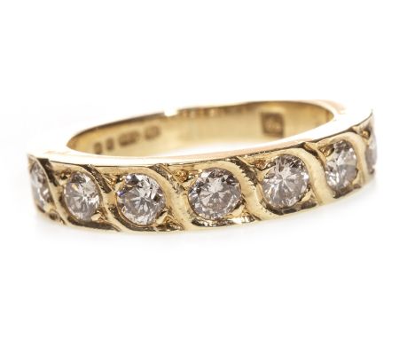 DIAMOND SET BAND, the seven round brilliant cut diamonds totalling approximately 0.70 carats overall, in eighteen carat gold,