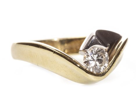 DIAMOND SOLITAIRE RING, set with a round brilliant cut diamond of approximately 0.23 carats, in a bi colour shank, marked 750