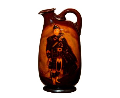 Doulton Kingsware whiskey jug with a Pipe Major on the face. The back has a symbol of a C and A overlapping. Doulton stamp. I