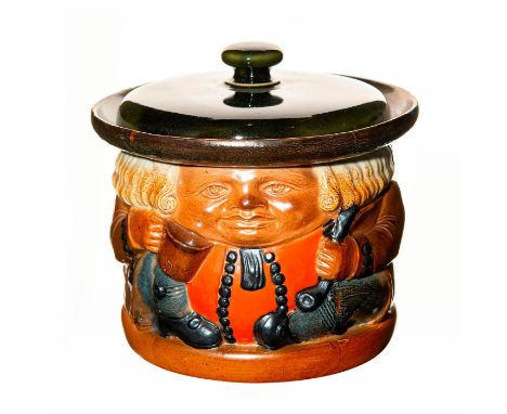 Simeon Toby Tobacco Jar, gentleman is dressed in an olive jacket, with an orange vest and blue buttons, with blue trousers. H