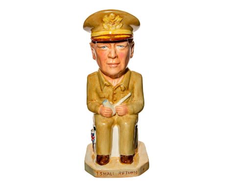 General Douglas MacArthur is dressed in uniform, which is a solid buff color with a green handle adorned with yellow stars. H