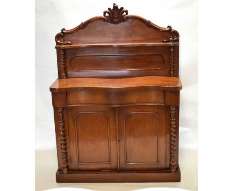 Victorian mahogany chiffonier with serpentine front, scroll pediment with central shelf raised on twisted columns, single ful