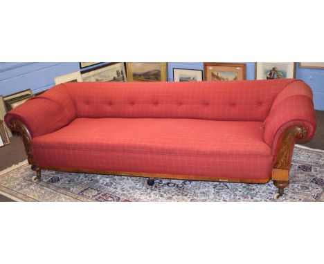 Mid-Victorian Chesterfield style large sofa, the carved oak arms joined by a plain frieze and with acanthus leaf detail uphol