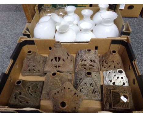 Box of opaline and two clear glass oil lamp shades, various shapes and sizes; together with  a box of cast iron, reticulated 