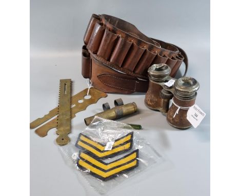 Leather cartridge belt together with a pair of opera glasses and two brass military button shields, cartridge case and corpor