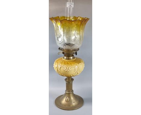 Early 20th century double oil burner lamp having clear and yellow etched shade above a ceramic moulded yellow reservoir on a 